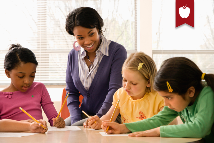 Teacher with students at desk